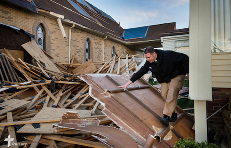 The Rev. Michael Meyer, manager of LCMS Disaster Response, climbs through debris Thursday, May 1, 2014, at Holy Trinity Lutheran Church in Tupelo, Miss. The church suffered catastrophic damage caused by a tornado earlier in the week. LCMS Communications/Erik M. Lunsford
