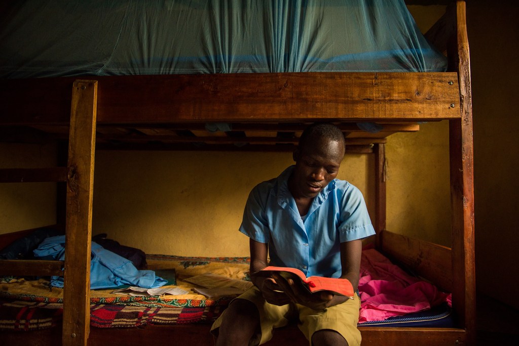 Moses Rutale studies the Book of Luke in his dormitory as he prepares to lead the other Udom students in the evening devotion. LCMS COMMUNICATIONS / Erik Lunsford