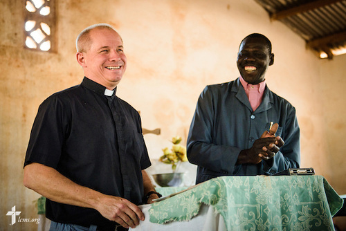The Rev. Gary Schulte, area director for West and Central Africa, greets church members following the Lutheran Church of Togo in Mire on Sunday, Feb. 12, 2017, in Mire, Togo. He is joined by the Rev. Lare Kolani Lambon, president of the Lutheran Church of Togo. LCMS Communications/Erik M. Lunsford