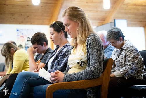 Young Adult Corps participants Courtney Haag (center), Madison Ezzell, and Hayden Duncan, pray together during evening worship on Wednesday, April 4, 2018, at Prince of Peace Lutheran Church, New Orleans. LCMS Communications/Erik M. Lunsford