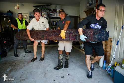 (R-L) The. Rev. Tim Niekerk, senior pastor at Salem Lutheran Church, Tomball, Texas, homeowner and church member Bob Rucoba, fellow church member Kelly Bedrich, and the Rev. Dr. Ross Johnson, director of LCMS Disaster Response, help haul flood-damaged home furnishings from Rucoba's house on Monday, Sept. 4, 2017, in Jersey Village, Texas. LCMS Communications/Erik M. Lunsford