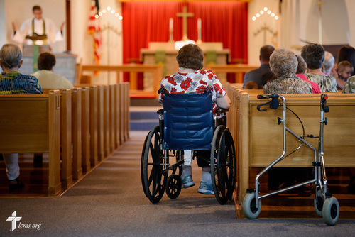 Jennifer Stripling listens as the Rev. Steven Struecker, full-time farmer and pastor of Immanuel Lutheran Church, Livermore, Iowa, and Zion Evangelical Lutheran Church, Lu Verne, Iowa, preaches at the church in Livermore on Sunday, July 9, 2017. LCMS Communications/Erik M. Lunsford