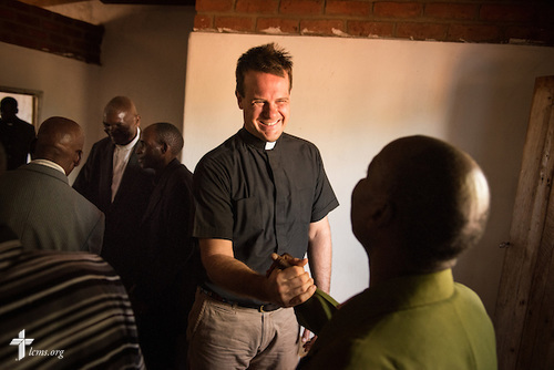 The Rev. Shauen Trump, LCMS missionary and area director for Eastern and Southern Africa, greets parishioners with traditional African handshakes before worship at a Confessional Lutheran Church–Malawi Synod parish on Sunday, Sept. 27, 2015, in Chingale, Malawi. LCMS Communications/Erik M. Lunsford