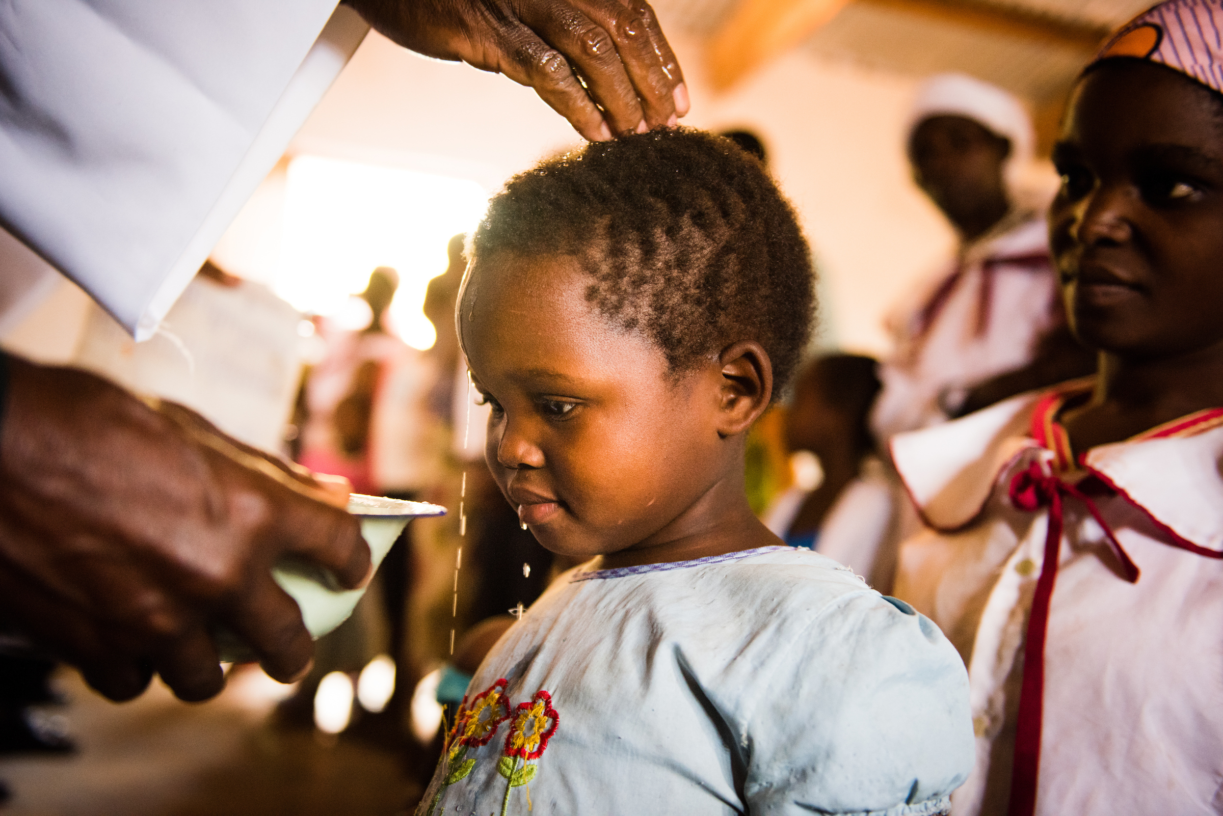 A child is baptized by the the Rev. Davis Wowa, executive chairman of the Confessional Lutheran Church–Malawi Synod, during worship on Sunday, Sept. 27, 2015, at a parish in Chingale, Malawi. LCMS Communications/Erik M. Lunsford