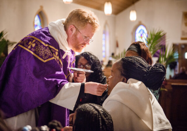 The Rev. Roy Axel Coats, pastor of Lutheran Church of the Redeemer, Baltimore, distributes the Sacrament on Palm Sunday, March 25, 2018. LCMS Communications/Erik M. Lunsford