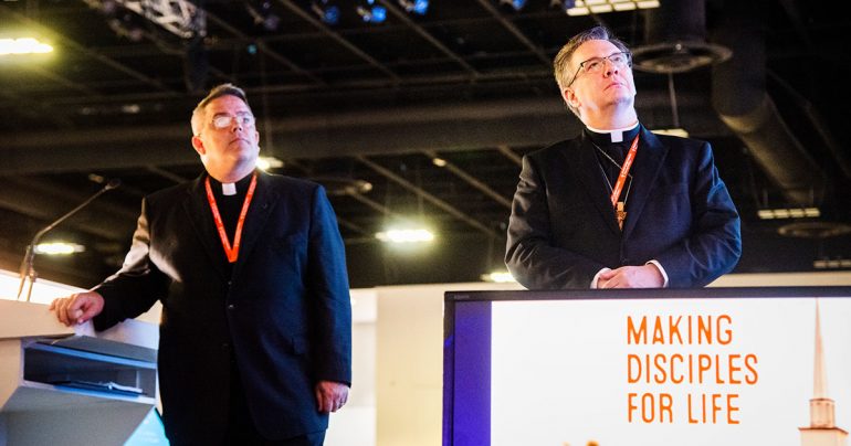 The Rev. Dr. R. Lee Hagan (left), chairman of Floor Committee 1 on National Witness, and the Rev. Christopher S. Esget, vice-chairman, join delegates in viewing a video on Making Disciples For Life, a new initiative of The Lutheran Church—Missouri Synod (LCMS). The video was part of the committee’s July 21 presentation to the 67th Regular Convention of the LCMS in Tampa, Fla. (LCMS/Frank Kohn)
