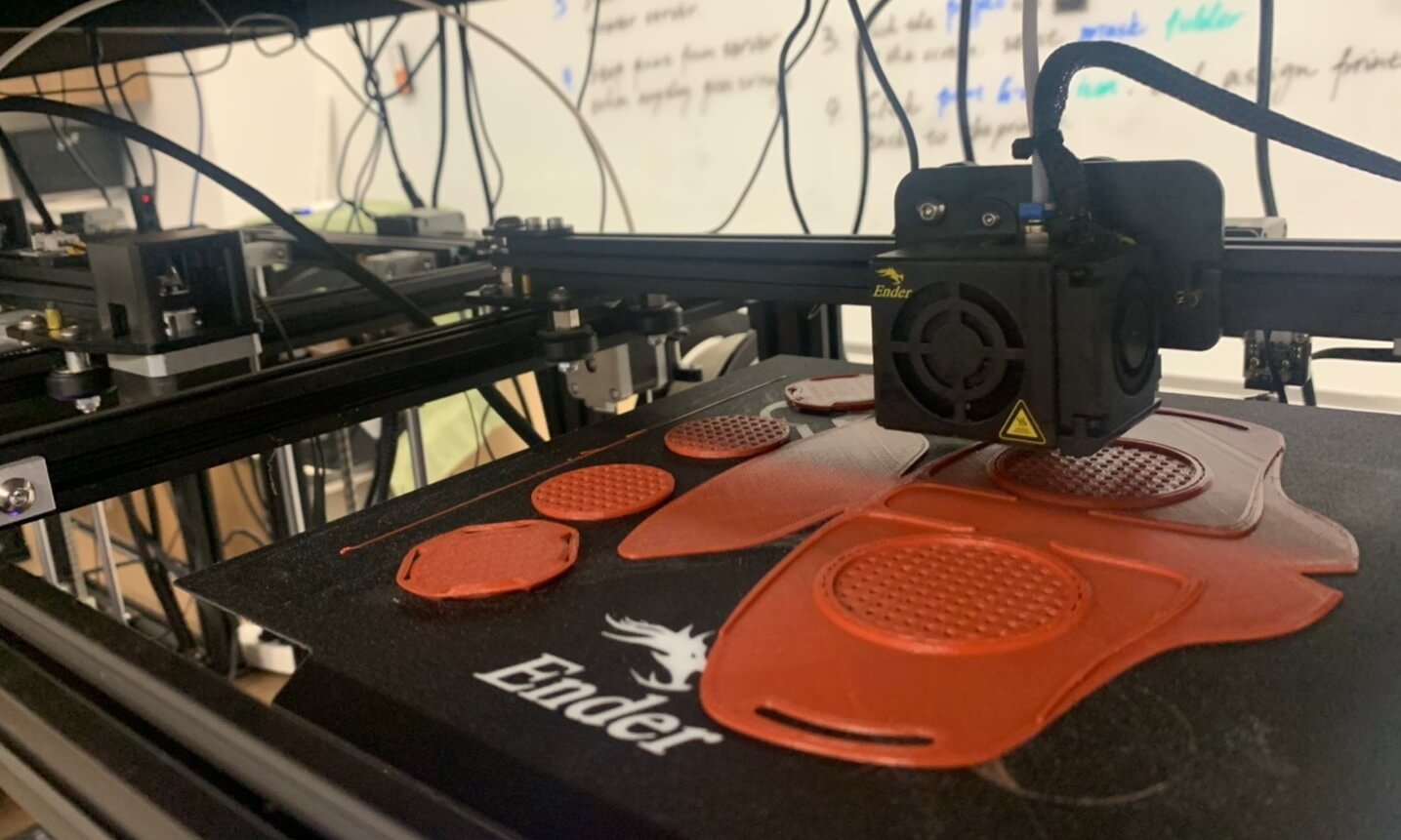 A 3D printer at the Concordia University Wisconsin Makerspace Lab prints a mask prototype.